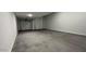 Spacious garage with concrete flooring and two large garage doors at 15782 W Cheryl Dr, Waddell, AZ 85355