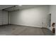 Clean garage space with overhead lighting and an entry door at 15782 W Cheryl Dr, Waddell, AZ 85355