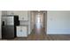 Modern kitchen adjacent to hallway with stainless steel appliances and white cabinetry at 15782 W Cheryl Dr, Waddell, AZ 85355