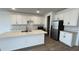 Contemporary kitchen with quartz countertops, stainless steel appliances, and white cabinetry at 15782 W Cheryl Dr, Waddell, AZ 85355
