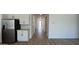 Modern kitchen view with stainless steel refrigerator, stylish cabinets, and an extended hallway with tile floors at 15782 W Cheryl Dr, Waddell, AZ 85355