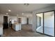 Spacious kitchen with modern appliances blending seamlessly into the adjacent living area, featuring tile floors at 15782 W Cheryl Dr, Waddell, AZ 85355