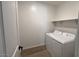 Functional laundry room with washer, dryer, and convenient shelving unit at 15782 W Cheryl Dr, Waddell, AZ 85355