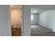 View of half bath adjacent to a carpeted living room with ample light, and warm colors, a convenient layout at 15782 W Cheryl Dr, Waddell, AZ 85355