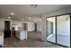 Open floor plan featuring an island kitchen, stainless appliances, and sliding glass doors at 15782 W Cheryl Dr, Waddell, AZ 85355