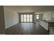 Open-concept living room with sliding glass doors and tile floors, creating a seamless indoor-outdoor flow at 15782 W Cheryl Dr, Waddell, AZ 85355