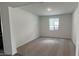 A view of an empty living space with neutral carpet at 15782 W Cheryl Dr, Waddell, AZ 85355