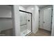 Contemporary shower stall with glass door and tiled floor in a spacious, well-lit bathroom at 15782 W Cheryl Dr, Waddell, AZ 85355