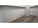 Spacious walk-in closet with ample storage space and neutral carpeting at 15782 W Cheryl Dr, Waddell, AZ 85355