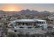 Desert home aerial view showcasing a patio, pool, and beautiful mountain views at sunset at 15830 E Eagle Crest Rd, Fountain Hills, AZ 85268