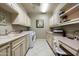 Well-lit laundry room with white cabinets, sink, washer, dryer, and a built-in desk area at 15830 E Eagle Crest Rd, Fountain Hills, AZ 85268