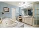 Spacious bathroom featuring jacuzzi tub, neutral countertops, and a well-lit vanity area at 15830 E Eagle Crest Rd, Fountain Hills, AZ 85268