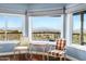 Inviting sitting area with hardwood floors, scenic views, and natural light from the expansive windows at 15830 E Eagle Crest Rd, Fountain Hills, AZ 85268
