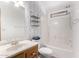 Bright bathroom featuring stylish wallpaper, a single sink vanity, toilet, and shower-tub combo at 17200 W Bell Rd # 1628, Surprise, AZ 85374
