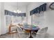 Cozy dining area with a round table, chandelier, and large windows at 17200 W Bell Rd # 1628, Surprise, AZ 85374