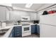 Modern kitchen with white appliances, two-tone cabinets and tile backsplash at 17200 W Bell Rd # 1628, Surprise, AZ 85374