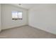 Bedroom with carpeted floors and a window showcasing a view of the neighborhood at 17300 W Dahlia Dr, Surprise, AZ 85388