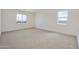 Bright bedroom with carpet, offering dual windows for ample natural light at 17300 W Dahlia Dr, Surprise, AZ 85388