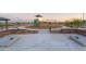 Open air cornhole area with walkways and landscape in a well-designed community at 17300 W Dahlia Dr, Surprise, AZ 85388