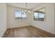 Bright dining room features tile floors, ample natural light, and a modern chandelier at 17300 W Dahlia Dr, Surprise, AZ 85388