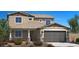 Inviting two-story home featuring a two-car garage, desert landscaping, and a neutral color palette at 17300 W Dahlia Dr, Surprise, AZ 85388