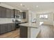 Modern kitchen featuring a center island, stainless steel appliances, gray cabinetry, and light countertops at 17300 W Dahlia Dr, Surprise, AZ 85388