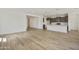 Open concept living space with tile floors, white walls, and a modern kitchen in the background at 17300 W Dahlia Dr, Surprise, AZ 85388