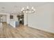 Open concept living space featuring tile floors, kitchen, and a modern light fixture at 17300 W Dahlia Dr, Surprise, AZ 85388