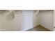 Bright walk-in closet with carpet flooring and metal rods for easy organization at 17300 W Dahlia Dr, Surprise, AZ 85388