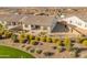 Aerial view of the gravel backyard with mature landscaping and a wrought iron fence at 17347 W Chama Dr, Surprise, AZ 85387