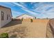 Spacious gravel backyard featuring a block fence and low-maintenance landscaping, perfect for outdoor living at 17347 W Chama Dr, Surprise, AZ 85387