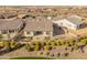 A peaceful backyard with manicured landscaping, gravel, and a wrought iron fence is shown from above at 17347 W Chama Dr, Surprise, AZ 85387