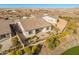 Birds eye view of a backyard featuring lush desert landscaping, a covered patio, and a private outdoor space at 17347 W Chama Dr, Surprise, AZ 85387