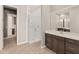 Modern bathroom featuring a glass-enclosed shower, spacious vanity, and tile flooring at 17347 W Chama Dr, Surprise, AZ 85387