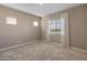 Comfortable bedroom featuring carpet flooring, neutral walls, and bright window at 17347 W Chama Dr, Surprise, AZ 85387