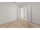The bedroom showcases a neutral carpet, white walls, and an open doorway at 17347 W Chama Dr, Surprise, AZ 85387