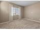 Bedroom featuring carpet flooring, neutral walls, and bright window with curtains at 17347 W Chama Dr, Surprise, AZ 85387
