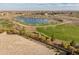 Community aerial shot shows a lake and green space, complemented by desert landscaping and walking paths at 17347 W Chama Dr, Surprise, AZ 85387