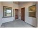 Covered entryway featuring private entrance and separate doors with sidelight windows at 17347 W Chama Dr, Surprise, AZ 85387