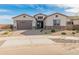 Charming single-story home featuring stone accents, neutral stucco, paver driveway, and a two-car garage at 17347 W Chama Dr, Surprise, AZ 85387