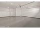 Attached garage with painted floor, and a white door to backyard at 17347 W Chama Dr, Surprise, AZ 85387