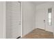 Hallway features tile flooring, white walls, and two paneled doors at 17347 W Chama Dr, Surprise, AZ 85387