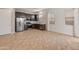 Open kitchen with stainless steel appliances and ample counter space at 17347 W Chama Dr, Surprise, AZ 85387