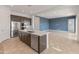 Spacious kitchen with stainless steel appliances, an island with bar seating, and an open-concept layout at 17347 W Chama Dr, Surprise, AZ 85387