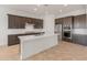 Open kitchen features stainless steel appliances, a center island, and dark wood cabinetry at 17347 W Chama Dr, Surprise, AZ 85387