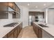 This kitchen offers ample counter space, stainless steel appliances, and dark wood cabinets at 17347 W Chama Dr, Surprise, AZ 85387