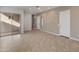 Spacious living room featuring tile floors and sliding glass doors to a private patio at 17347 W Chama Dr, Surprise, AZ 85387