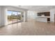 Open floor plan with a view from the living room to the kitchen and patio, creating a seamless indoor-outdoor living experience at 17347 W Chama Dr, Surprise, AZ 85387