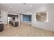 Bright and airy living space featuring a kitchen with stainless steel appliances and an attached living room at 17347 W Chama Dr, Surprise, AZ 85387