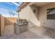 Covered patio area with a built-in grill and space for outdoor seating at 17347 W Chama Dr, Surprise, AZ 85387